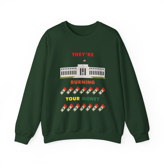 Green crewneck sweatshirt with the words "They're Burning Your Money" in large bold letters. The design has a digital drawing of the United States Federal reserve building in Washington D.C. and it features drawings of burning dollar bills.